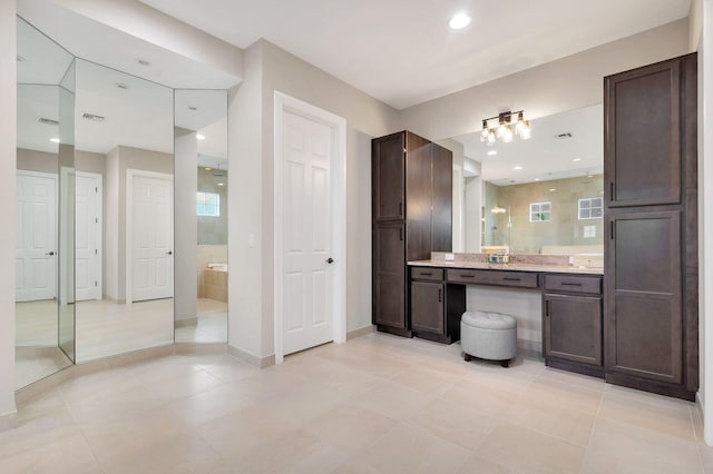 bathroom featuring tile patterned floors, vanity, and walk in shower