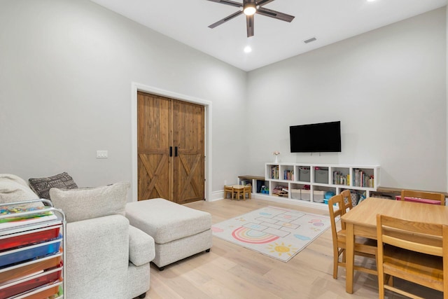 living room with hardwood / wood-style flooring and ceiling fan