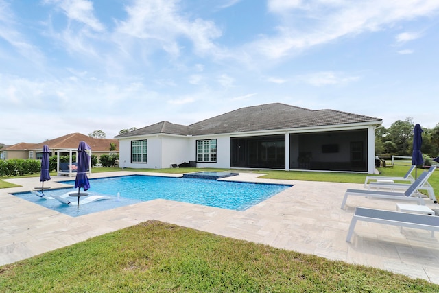 view of pool with a lawn, a patio, and a hot tub