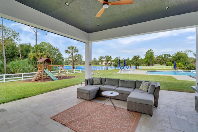 view of patio / terrace with a playground, an outdoor living space, a water view, and ceiling fan