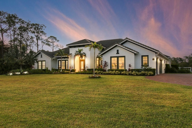 view of front of property with a lawn and a garage