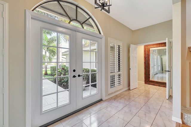 entryway with french doors and light tile patterned floors