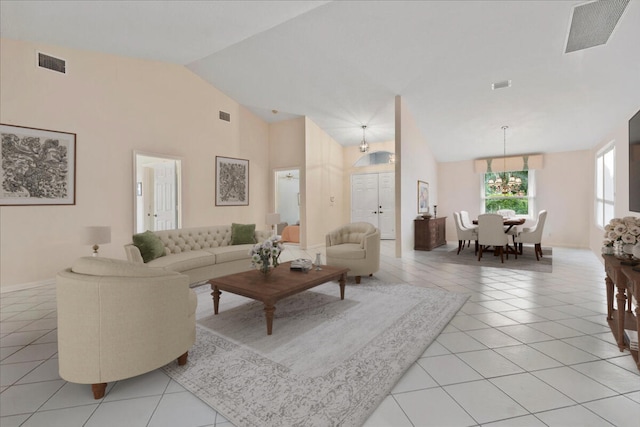 tiled living room with high vaulted ceiling and an inviting chandelier