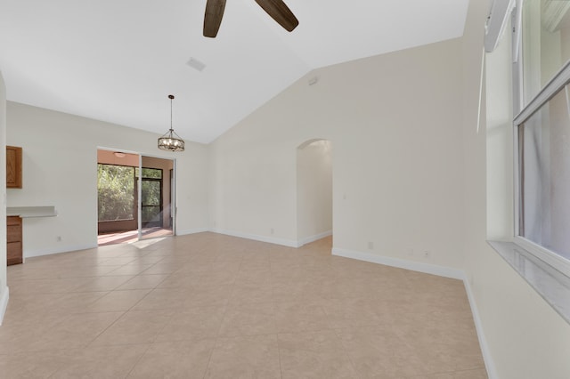 unfurnished living room featuring high vaulted ceiling, ceiling fan with notable chandelier, and light tile patterned floors