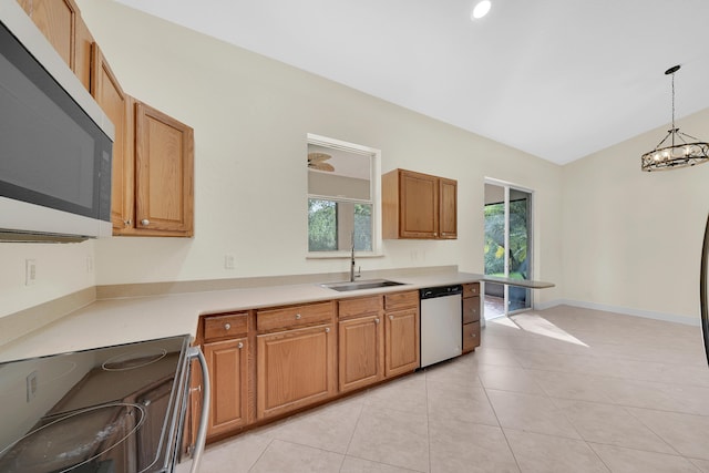 kitchen featuring appliances with stainless steel finishes, sink, a wealth of natural light, and pendant lighting