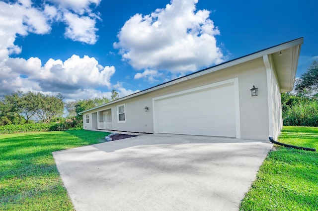 view of home's exterior featuring a lawn and a garage