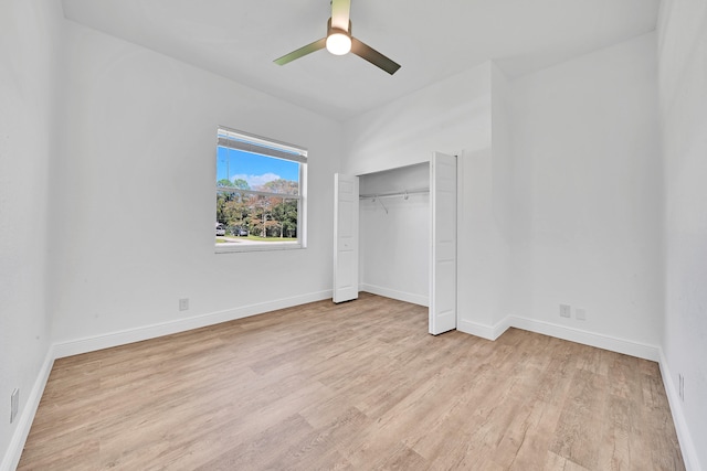 unfurnished bedroom with light hardwood / wood-style floors, a closet, and ceiling fan