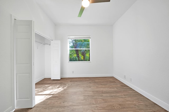 unfurnished bedroom with a closet, ceiling fan, and wood-type flooring