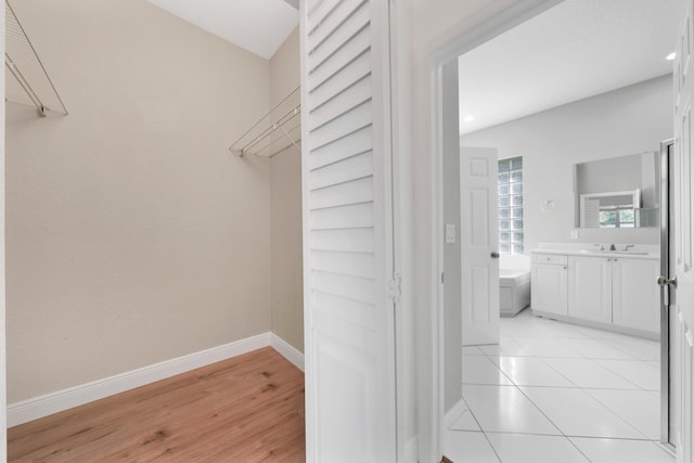 spacious closet featuring light hardwood / wood-style floors and sink