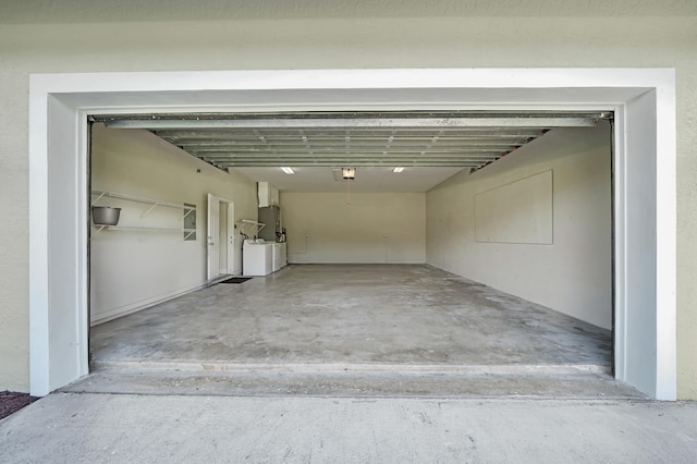 garage with a garage door opener and washing machine and clothes dryer