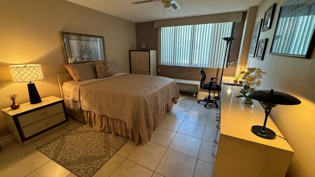 tiled bedroom featuring a textured ceiling and ceiling fan