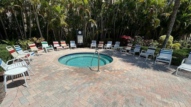 view of pool featuring a community hot tub and a patio