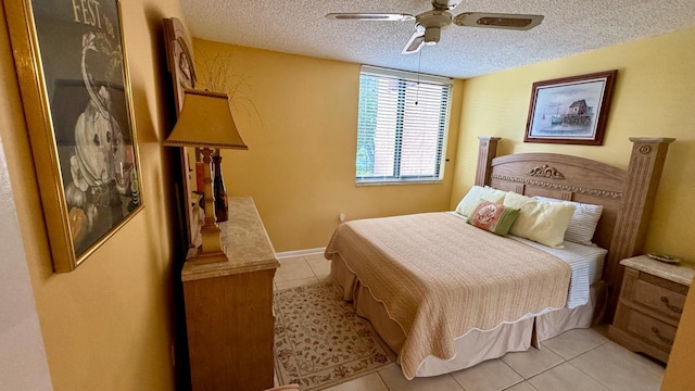 tiled bedroom featuring ceiling fan and a textured ceiling