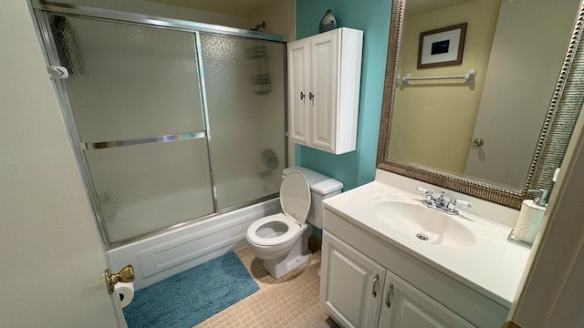 full bathroom with vanity, toilet, and combined bath / shower with glass door