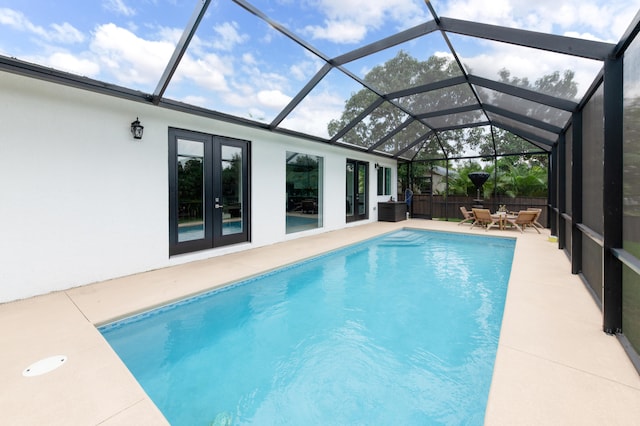 view of pool featuring french doors, a patio area, and a lanai