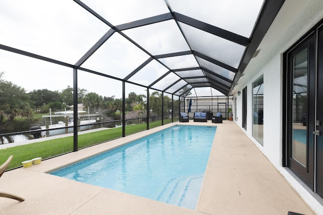 pool featuring a patio area, a water view, outdoor lounge area, a lanai, and a lawn