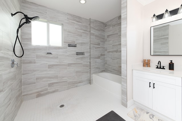 bathroom with vanity and tiled shower