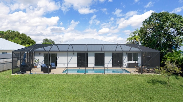 rear view of property with a yard, a patio, and a lanai