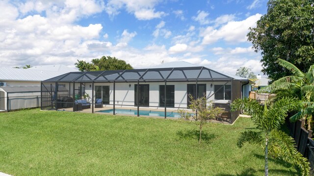 rear view of property featuring a fenced backyard, a yard, a patio, a lanai, and an outdoor pool