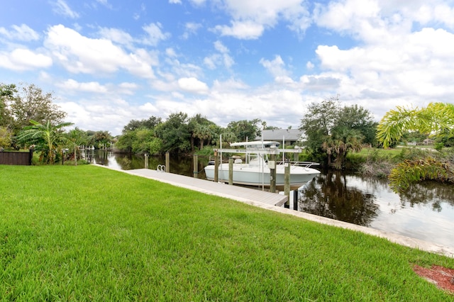dock area with a yard, a water view, and boat lift