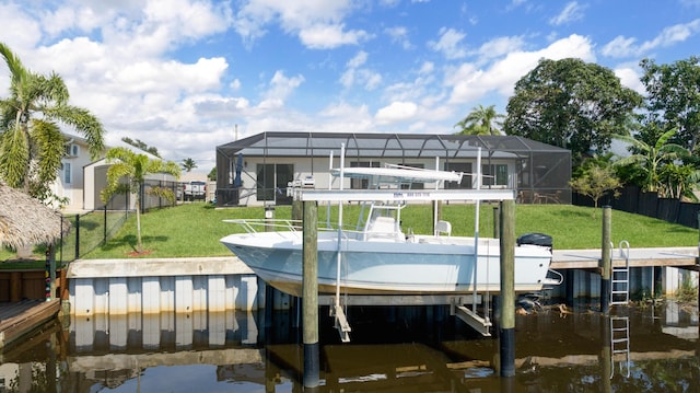 dock area with fence, a water view, glass enclosure, boat lift, and a lawn