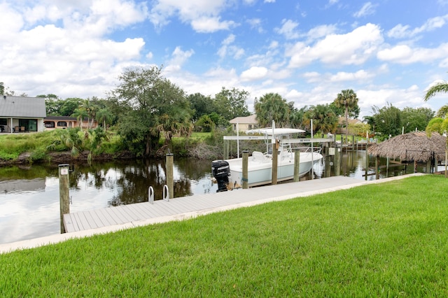 view of dock featuring a water view and a lawn