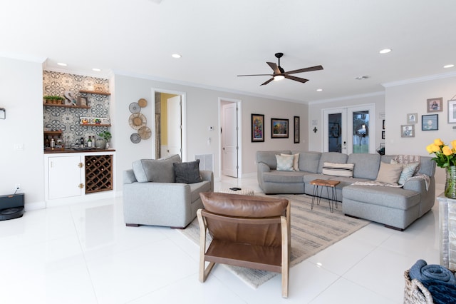 living room featuring crown molding, ceiling fan, and light tile patterned floors