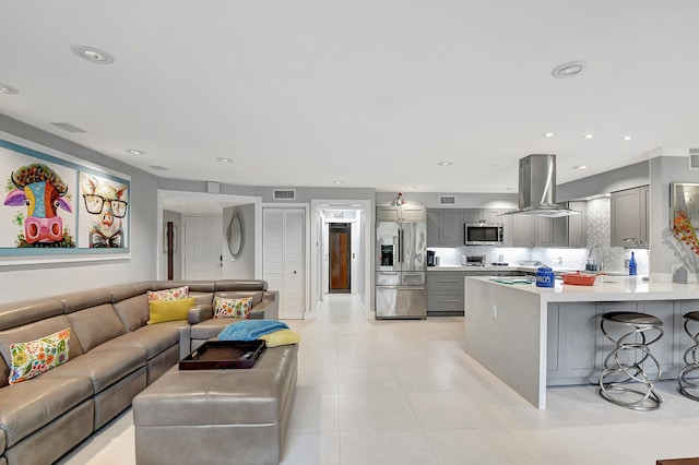 living room with sink and light tile patterned floors