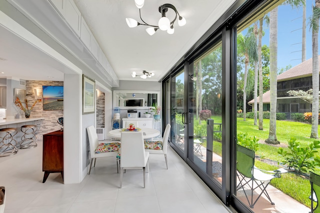 sunroom / solarium with a wealth of natural light and a notable chandelier