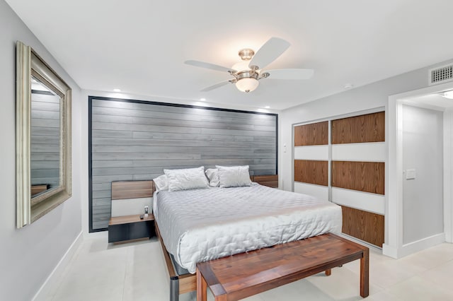 tiled bedroom featuring a closet and ceiling fan