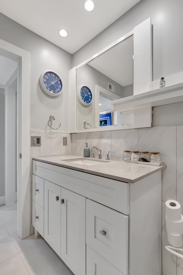 bathroom with vanity, tasteful backsplash, and tile patterned flooring