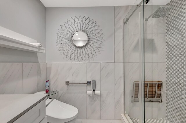 bathroom with walk in shower, tile walls, toilet, vanity, and tile patterned flooring