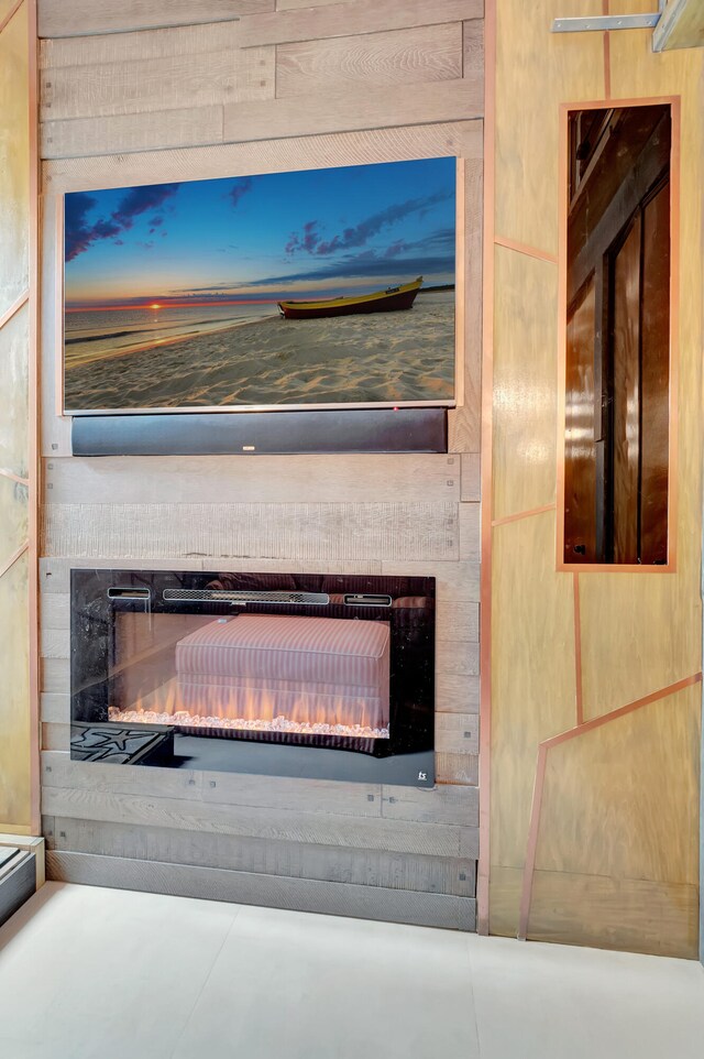 room details with wooden walls and a fireplace