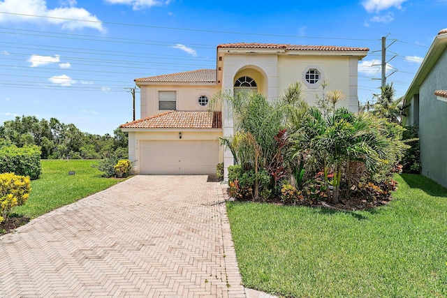 mediterranean / spanish-style home with a front lawn and a garage