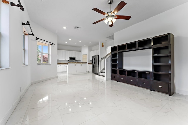 unfurnished living room with ceiling fan