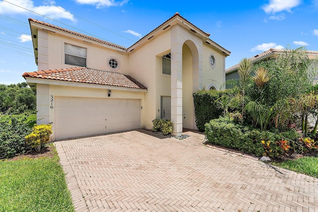 mediterranean / spanish-style house featuring a garage