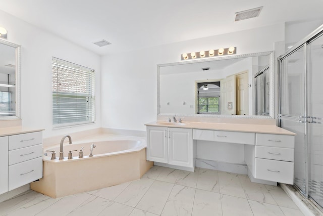 bathroom featuring plenty of natural light, shower with separate bathtub, and vanity