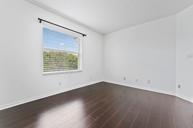 empty room with a textured ceiling and hardwood / wood-style flooring