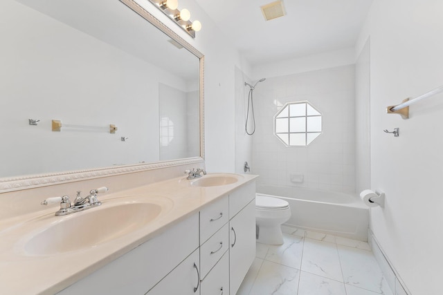 full bathroom featuring toilet, vanity, and tiled shower / bath