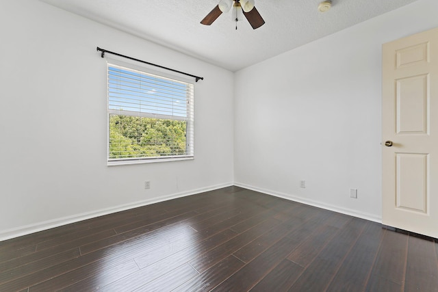 spare room featuring ceiling fan, dark hardwood / wood-style floors, and a textured ceiling