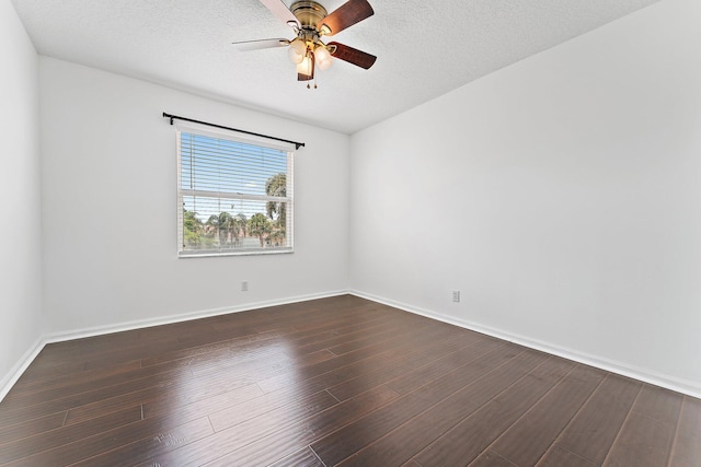 empty room featuring a textured ceiling, dark hardwood / wood-style floors, and ceiling fan