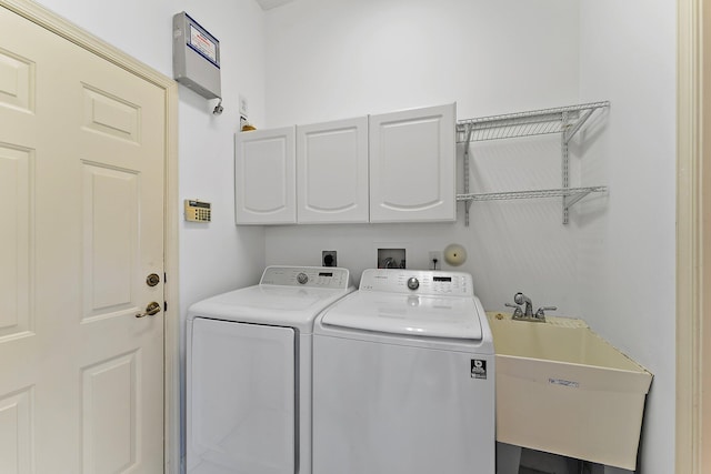 laundry area with cabinets, sink, and washer and dryer