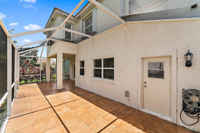 exterior space with a patio and glass enclosure