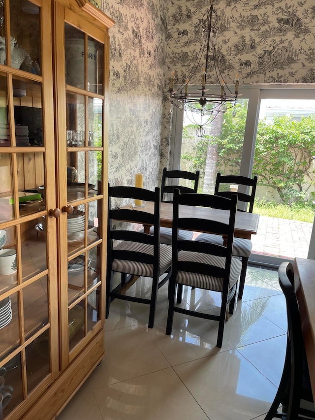 tiled dining room with a notable chandelier