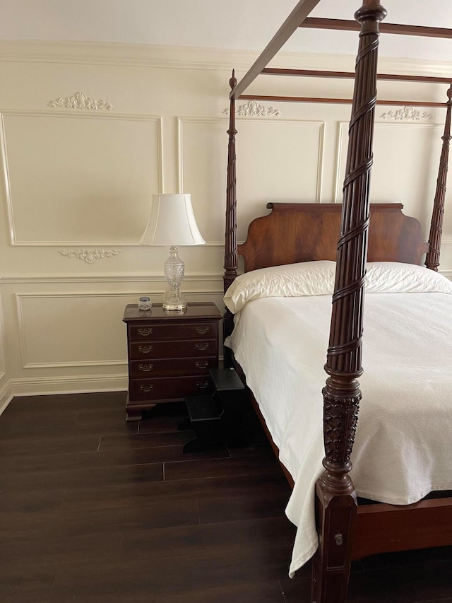 bedroom featuring dark hardwood / wood-style floors and crown molding