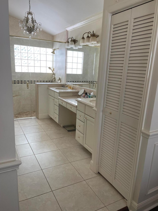 bathroom featuring walk in shower, vanity, tile patterned flooring, a chandelier, and lofted ceiling