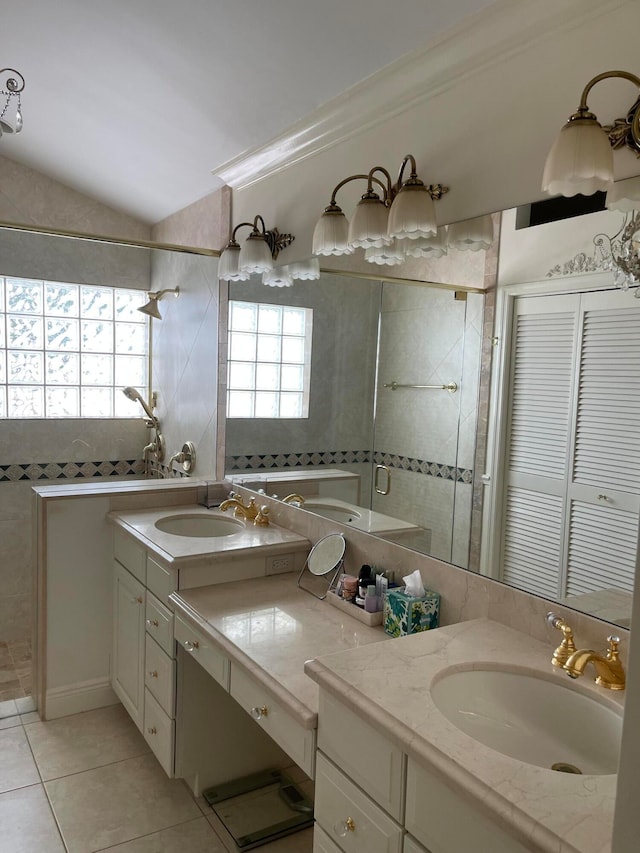 bathroom featuring ornamental molding, vanity, lofted ceiling, tiled shower, and tile patterned floors