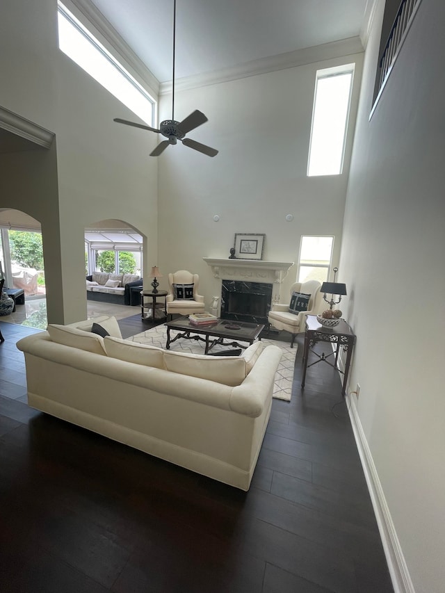 living room with plenty of natural light, wooden walls, and ceiling fan