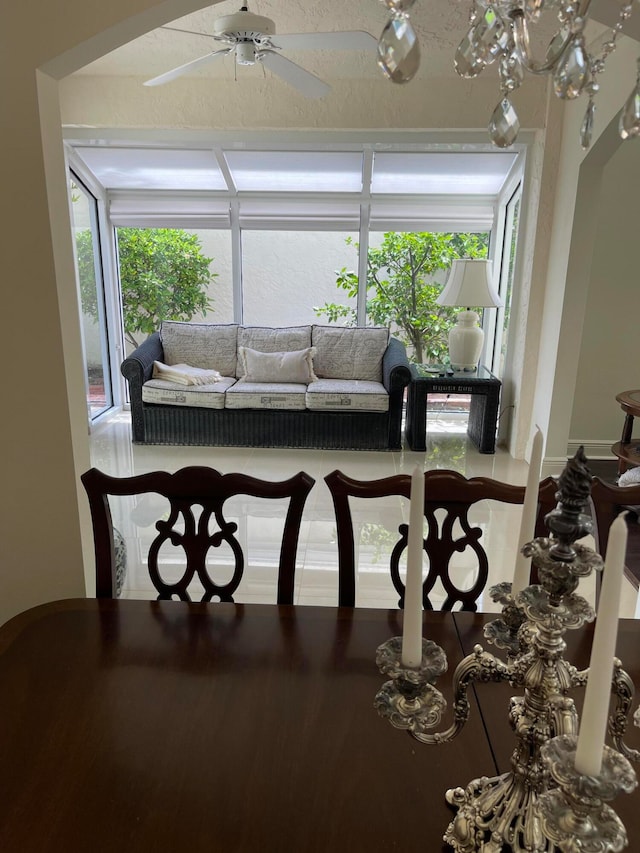 dining space featuring ceiling fan and a textured ceiling