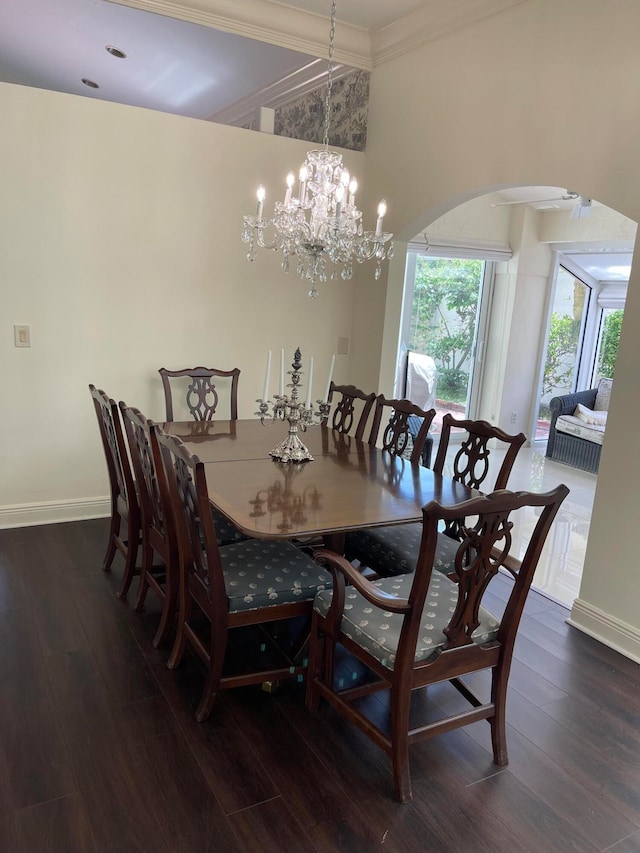 dining space with dark hardwood / wood-style flooring, a chandelier, and crown molding